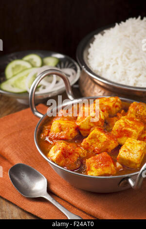 Paneer and sweet pepper curry with rice on wooden background Stock Photo