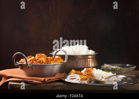 Paneer and sweet pepper curry with rice on wooden background Stock Photo