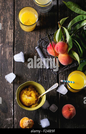 A glass of orange juice on a table in a blue interior. Stock Photo by  puhimec