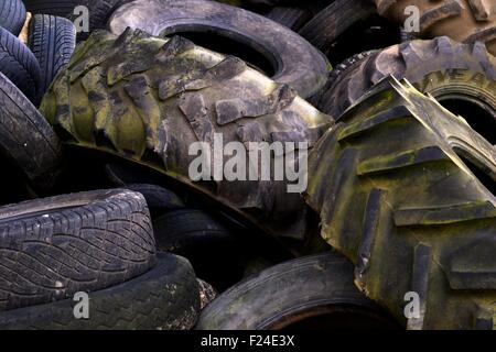 Large Tractor  and car tyre pile Stock Photo