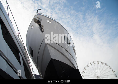 Southampton, UK. 11th September 2015. Southampton Boat Show 2015. A Sunseeker bow with the boat show eye ferris wheel in the background. Credit:  MeonStock/Alamy Live News Stock Photo