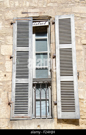 Half-open white shutters with juliet balcony in town centre of Sarlat, France Stock Photo