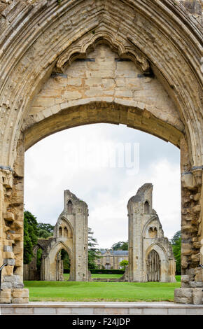 The ruins of Glastonbury Abbey viewed through an arch in the Lady Chapel, Glastonbury, Somerset, England, UK Stock Photo