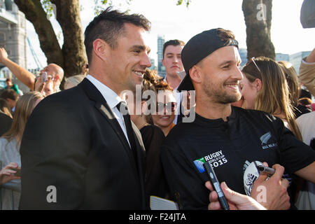 London, UK. 11th September 2015. Dan Carter poses for a picture with a fan at Tower Bridge after the welcoming ceremony for the New Zealand rugby team for the 2015 Rugby World Cup. 20 teams from around the world will be competing to win the Webb Ellis Cup and declared RWC 2015 winners. New Zealand are the current title holders, winning the trophy in 2011. Credit: Elsie Kibue / Alamy Live News Stock Photo