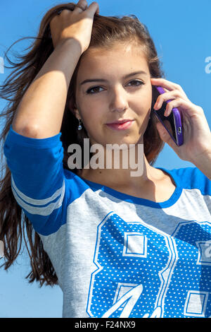 Beautiful teenage girl calling on mobile phone Stock Photo