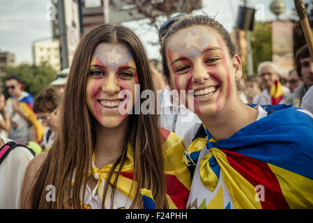 Sept. 11, 2015 - Two young catalan pro-independence supporter have the Catalan colors painted on her faces during the manifestation in Barcelona's Meridiana Street on Catalonia's national day for the independence from Spain © Matthias Oesterle/ZUMA Wire/Alamy Live News Stock Photo