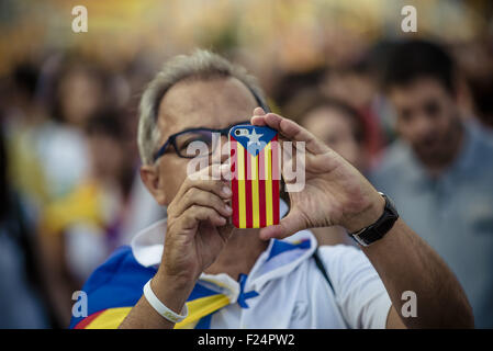 Sept. 11, 2015 - A catalan pro-independence supporter takes a picture with his phone covered with the Catalan colors at the end of the manifestation in Barcelona's Meridiana Street on Catalonia's national day for the independence from Spain © Matthias Oesterle/ZUMA Wire/Alamy Live News Stock Photo