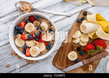 Portion of Cornflakes with fresh Fruits (close-up shot) Stock Photo