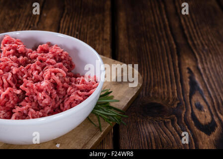Minced Meat (Beef) as detailed close-up shot on dark wooden background Stock Photo