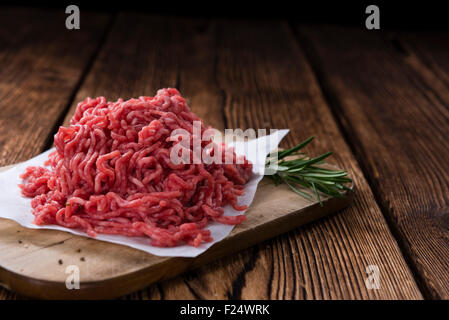 Minced Meat (close-up shot) on vintage wooden background Stock Photo