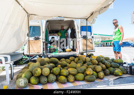Hawking melons at a gas station run by two friendly vendors in Andalusia, Spain Stock Photo