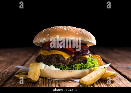 Homemade Burger with French Fries on an old wooden table Stock Photo