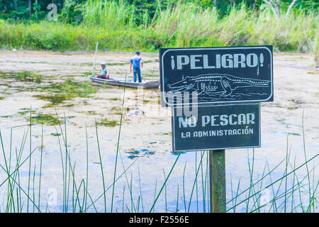 Crocodile warning sign near an artificial pond in Tikal Guatemala's national park Stock Photo