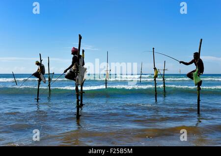 Sri Lanka, Southern Province, Galle district, Midigama beach, Pole Fishermen or Stilt Fishermen ply their trade along the Galle coastline Stock Photo