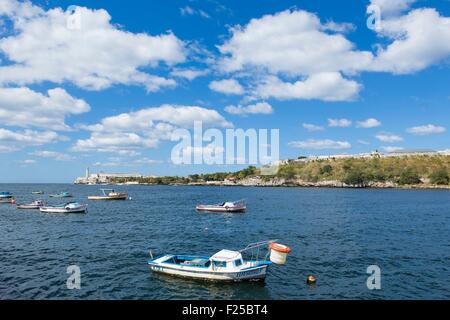 Cuba, Ciudad de la Habana province, Havana, fishing boats moored in front of San Carlos de la Cabana fortress and Castillo de los tres reyes del Morro fortress Stock Photo