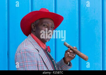 Cuba, Ciudad de la Habana province, Habana Vieja district listed as World Heritage by UNESCO, La Havana, man dressed as Beny More on Cathedral square smoking a cigar Stock Photo