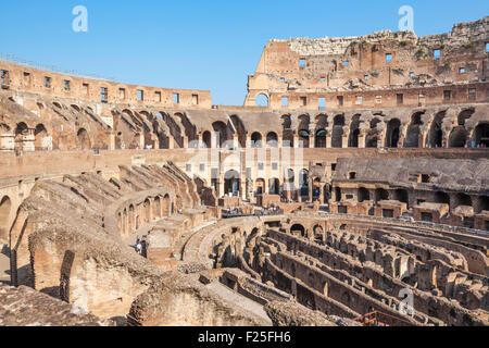 tourists wandering around the ruined interior of the roman colosseum or Flavian Amphitheatre  Rome Lazio Region Italy EU Europe Stock Photo