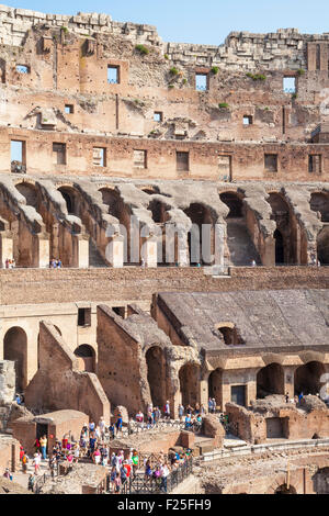 tourists wandering around the ruined interior of the roman colosseum or Flavian Amphitheatre  Rome Lazio Region Italy EU Europe Stock Photo