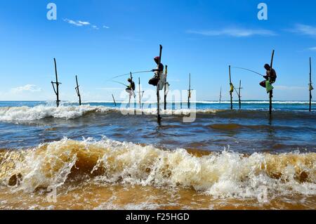 Sri Lanka, Southern Province, Galle district, Midigama beach, Pole Fishermen or Stilt Fishermen ply their trade along the Galle coastline Stock Photo