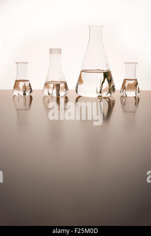 Measuring glasses on a table of a chemical laboratory and free space Stock Photo
