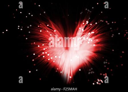 red colored abstract heart made from fibers  lights  in darkness ( love concept ) Stock Photo