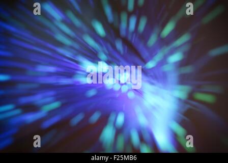 colored particles fly in space of the optical fiber and circling ( abstract blur background  ) Stock Photo