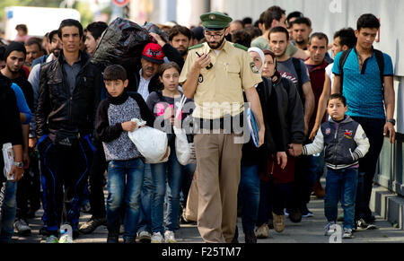 Munich, Germany. 12th Sep, 2015. Refugees, recently arrived by train, are accompanied to accommodation at the central station in Munich, Germany, 12 September 2015. PHOTO: SVEN HOPPE/DPA/Alamy Live News Stock Photo