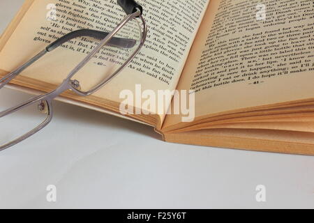 It is an open book and glasses on it Stock Photo