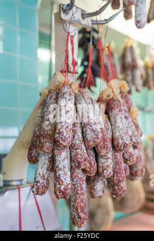 Many french saucisson hanging at a butcher shop. Stock Photo