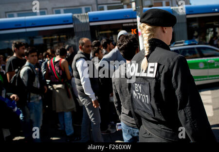 Munich, Germany. 12th Sep, 2015. Refugees, recently arrived by train, are accompanied to accommodation from the central station in Munich, Germany, 12 September 2015. PHOTO: SVEN HOPPE/DPA/Alamy Live News Stock Photo