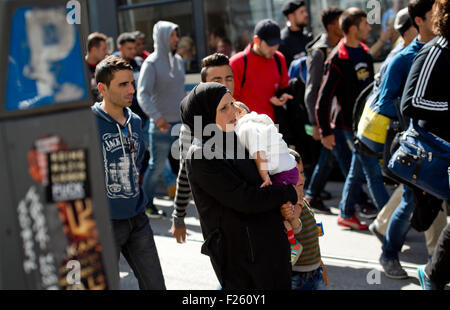 Munich, Germany. 12th Sep, 2015. Refugees, recently arrived by train, are accompanied to accommodation from the central station in Munich, Germany, 12 September 2015. PHOTO: SVEN HOPPE/DPA/Alamy Live News Stock Photo