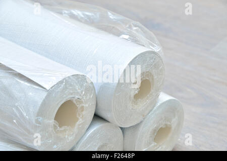 many gray wallpaper rolls on floor Stock Photo