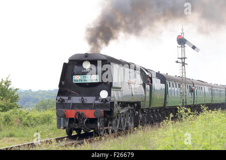 The preserved steam locomotive, 'Wadebridge' 34007, pulling passenger carriages on the 'Watercress Line', Hampshire, England, UK Stock Photo