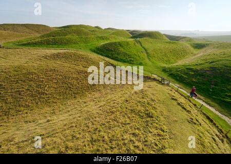 Maiden Castle Iron Age hill fort, Dorset. Four ramparts and three ditches of complex earthwork defences of the western entrance Stock Photo