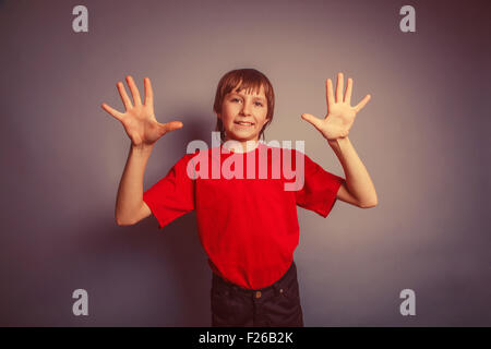 European-looking boy of ten years shows a figure ten fingers on Stock Photo