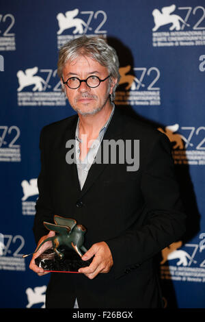 Venice, Italy. 12th Sep, 2015. The director Christian Vincent poses with the Best Screenplay Award for the movie 'L'Hermine', during the award winners photocall during the 72nd Venice Film Festival, at the Lido of Venice, Italy, Sept. 12, 2015. © Ye Pingfan/Xinhua/Alamy Live News Stock Photo