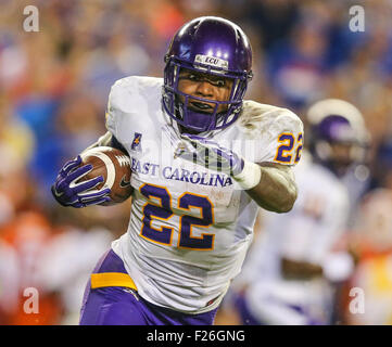 East Carolina running back Chris Hairston (22) rushes for yardage past  Florida linebacker Jarrad Davis (40) and Justus Reed (97) during the first  half of an NCAA college football game in Gainesville