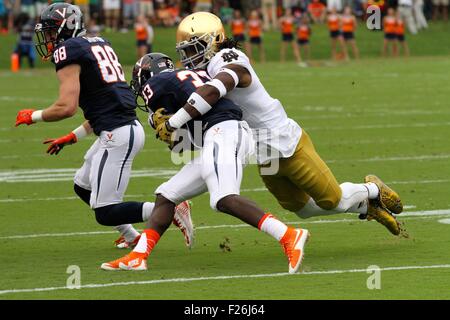 Charlottesville, Virginia, USA. 12th September, 2015. Virginia Cavaliers running back Olamide Zaccheaus (33) is tackled during the NCAA Football game between the Notre Dame Fighting Irish and the Virginia Cavaliers at Scott Stadium in Charlottesville, VA. Credit:  Cal Sport Media/Alamy Live News Stock Photo