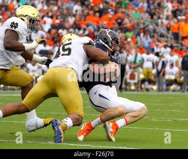 Charlottesville, Virginia, USA. 12th September, 2015. Virginia Cavaliers quarterback Matt Johns (15) is sacked by Notre Dame Fighting Irish defensive lineman Romeo Okwara (45) during the NCAA Football game between the Notre Dame Fighting Irish and the Virginia Cavaliers at Scott Stadium in Charlottesville, VA. Credit:  Cal Sport Media/Alamy Live News Stock Photo