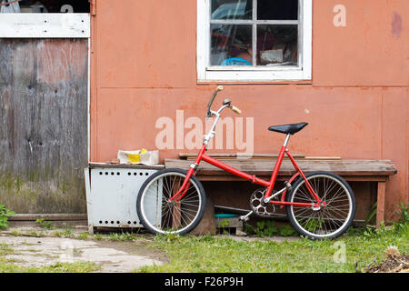 Old vintage bicycle near shed in village Stock Photo