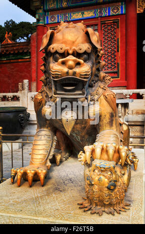 Close up frontal view of bronze gold plated imperial lion statue at Forbidden city palace in Beijing Stock Photo