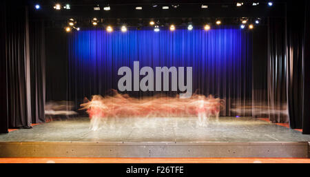 on stage dressed ballet performance in a theater blurred motion movements of dancers under stage lights Stock Photo