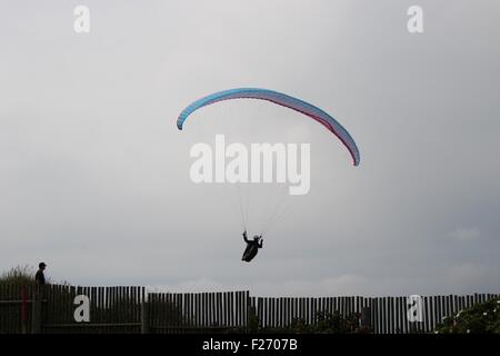 Paraglider in Lokken, Denmark, Europe, flying over the fence of a Camping site on the dunes. Stock Photo