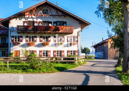 Bavaria Germany holiday resort. Typical half-timbered farm houses with shuttered windows and flower pots Stock Photo