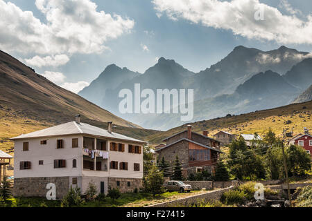 Mountain houses with clouds in Ayder Plateau, Rize, Turkey. Stock Photo