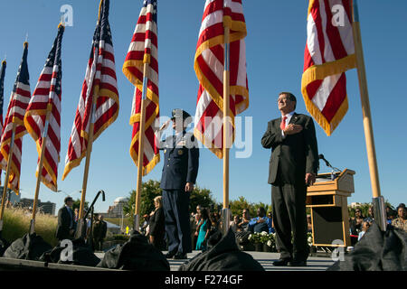 U.S. Defense Secretary Ash Carter and Air Force Gen. Paul Selva stand for the national anthem during a ceremony to remember the victims of the 9/11 terror attacks at the Pentagon Memorial on the anniversary of the attacks September 11, 2015 in Arlington, Virginia. Stock Photo