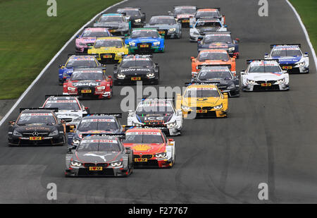 Oschersleben, Germany. 13th Sep, 2015. DTM drivers drive close to eachother after the starting signal during the DTM German Touring Car Championship in the etropolis arena in Oschersleben, Germany, 13 September 2015. PHOTO: JENS WOLF/DPA/Alamy Live News