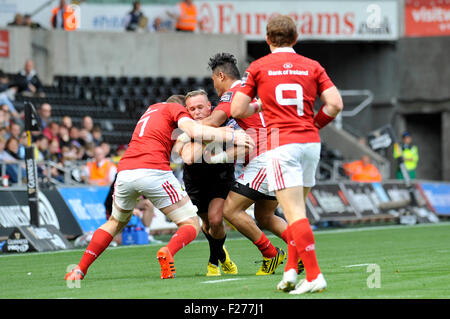 Swansea, Wales, UK. 13th Sep, 2015. Guiness Pro 12 -  Ospreys v Munster at the Liberty Stadium in Swansea : Ospreys Hanno Dirksen is caught by the Munster defence.  Credit:  Phil Rees/Alamy Live News Stock Photo