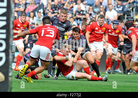 Swansea, Wales, UK. 13th Sep, 2015. Guiness Pro 12 -  Ospreys v Munster at the Liberty Stadium in Swansea : Rory Scannell of Munster is tackled by the Ospreys   Credit:  Phil Rees/Alamy Live News Stock Photo