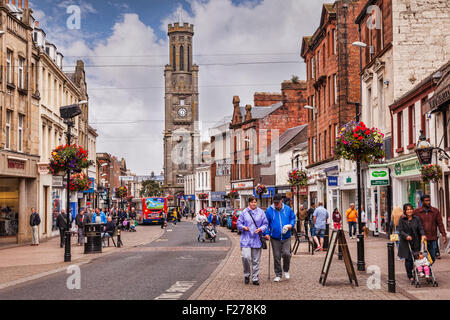A busy shopping day in High Street, Ayr, South Ayrshire, Scotland. The clock tower is the Wallace Tower. Stock Photo